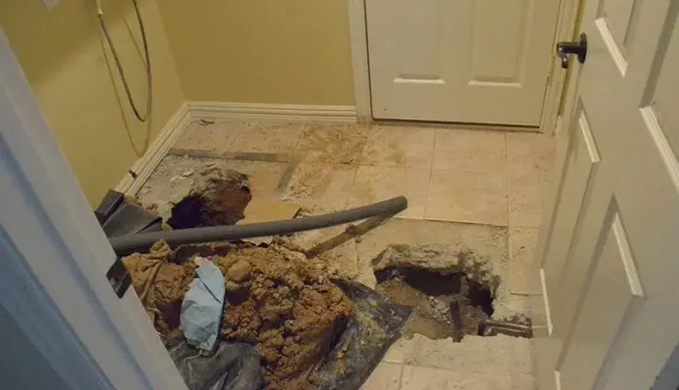 Floor opened to reach a leaking line under a slab foundation in Leander